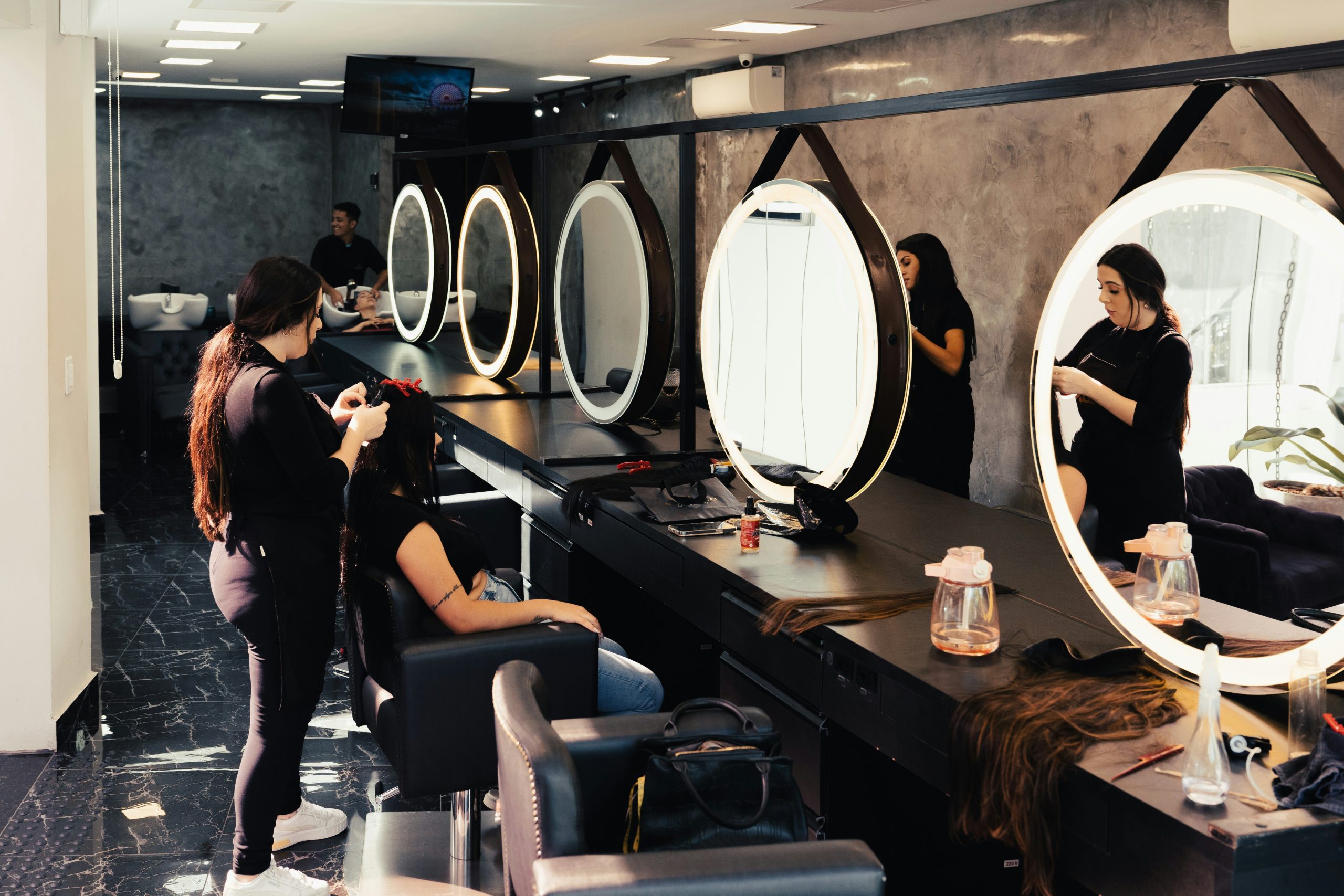 hair stylist and client in front of mirror