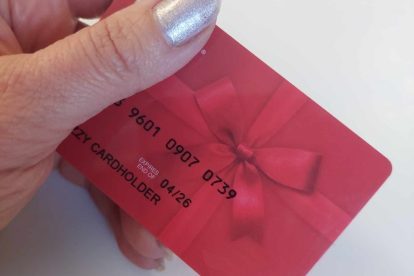 image of a hand holding a red giftcard