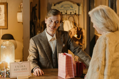 customer and salesman at desk with christmas tree
